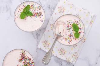 Fruit mousse, made from jelly and cottage cheese, in glasses, decorated with sprinkles and mint,