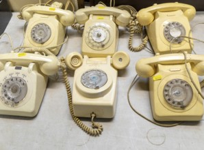 Vintage analogue dial landline telephones on display at auction, UK