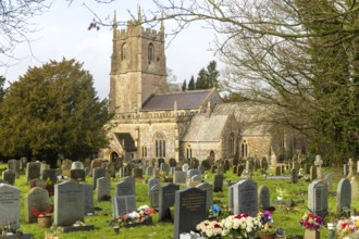 Headstones in graveyard of village parish church of Saint James, Avebury, Wiltshire, England, UK
