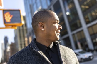 Professional man confidently walking through the vibrant city streets, looking ahead with a happy