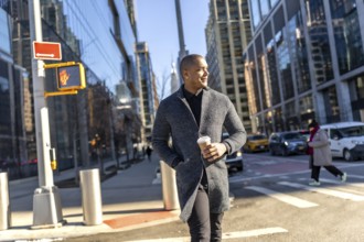 Young man in a stylish coat walks manhattan streets holding a coffee, confidently navigating