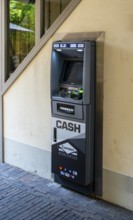 Euronet cash machine at the gateway to a backyard, Potsdam, Brandenburg, Germany