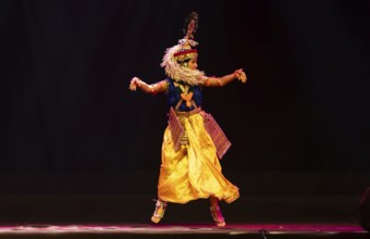 An artist perform classical Manipuri Ras Leela during a cultural evening program at Shilpgram