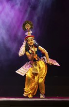 An artist perform classical Manipuri Ras Leela during a cultural evening program at Shilpgram