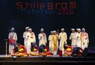Artists perform 'Ojapali' folk song with Deodhani dance during a cultural evening program at