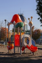 Colorful kids plastic playground equipment with slides and climbing bars in Parc du Bassin