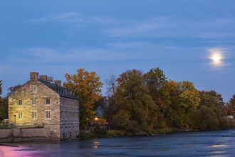 Illuminated Moulin Neuf - New Mill on Ile des Moulins and Des Mille-Iles river with supermoon