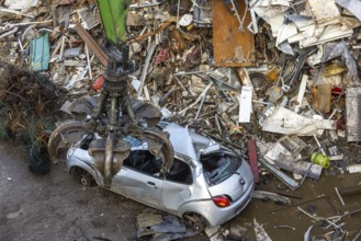 Scrap trade in a commercial port. A disused small car is scrapped. Mannheim, Baden-Württemberg,