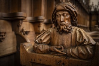 Carved half-figure, man with beard, oak choir stalls for monks' hour prayers, 1493 by Jörg Syrlin