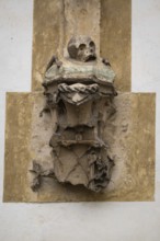 Weathered sculpture with skull, symbolizing transience in an ancient, Gothic style, Blaubeuren,
