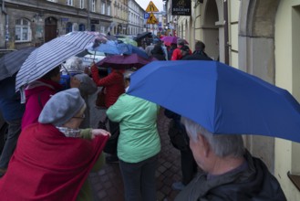 Tourists with umbrellas in Krakow, Poland