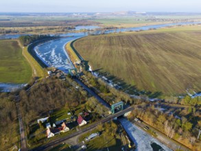Lock surrounded by fields and a river curve, with an adjacent village, aerial view, Niegripp lock,
