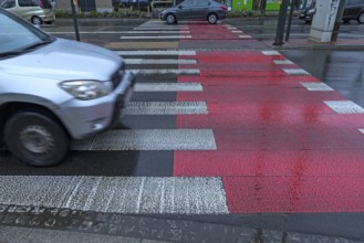 Zebra crossing marked in red and white, Krakow, Poland