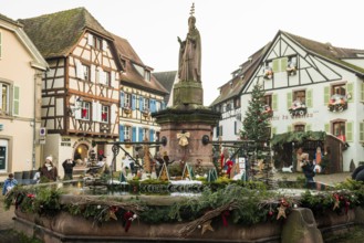 Christmassy decorated houses and fountains with half-timbered houses, Christmas market, Eguisheim,