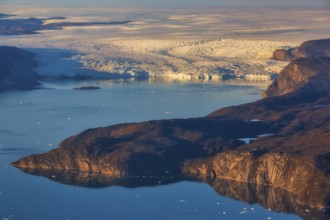 Aerial view of coast and Greenland ice sheet, Arctic landscape, frozen wilderness, glaciers and