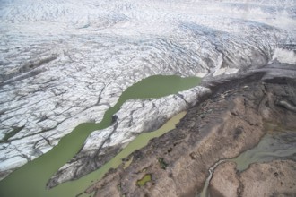 Aerial view of coast and Greenland ice sheet, Arctic landscape, frozen wilderness, glaciers and