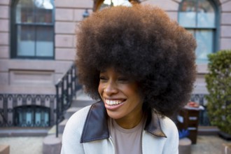 Cheerful young african american woman with a large afro hairstyle smiling genuinely, exuding joy