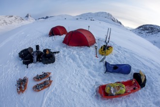 Tourists camp in a winter Arctic expedition skiing along Ikasartivaq Fjord, Sermersooq
