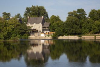 19th century multistory old cut stone home with weathered cedar shingles roof and backyard built on