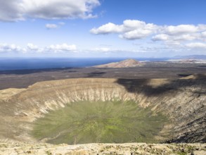 View of the Caldera Blanca volcano cauldron against blue sky with white clouds, Mancha Blanca,