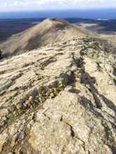 View from Caldera Blanca volcano against blue sky with white clouds, Mancha Blanca, Lanzarote,