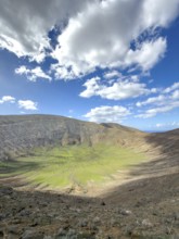 View of the Caldera Blanca volcano cauldron against blue sky with white clouds, Mancha Blanca,
