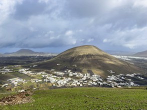 View from Montaña Blanca mountain to the town of Montaña Blanca with cloudy sky in the background,