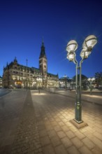 Hamburg City Hall with illuminated blue hour façade and street lamp in the foreground, Hamburg,