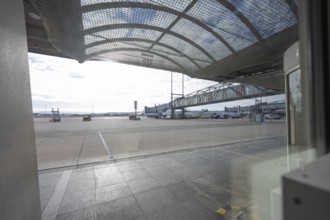 Extensive airport apron in bright sunlight, covered with a grid structure, Stuttgart Airport,