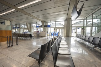 Modern, empty waiting area at the airport with elegant seats and large windows, Stuttgart Airport,