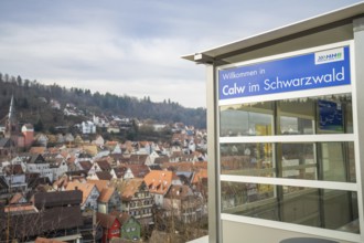 A Calw sign with a picturesque view of a village in the Black Forest, taking off the Hermann
