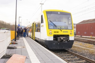 Yellow SWEG vehicle parked on the platform with several people waiting, the Hermann Hessebahn ride,