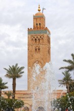 Minaret of the Koutoubia Mosque with water fountain from a fountain, landmark of Marrakech,