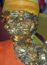 Statue of a monk in a Buddhist temple decorated with gold plates. Buddha, Buddhism, religion,