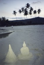 Children built a pagoda and a Buddha out of sand on the beach, Buddhism, religion, Koh Samui,