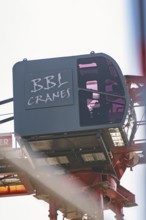 Close-up of a crane operator cabin with lettering in the construction zone, carpentry, new