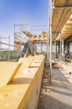 View of scaffolding with wooden panels under a clear sky, carpentry, new building, Stuttgart,