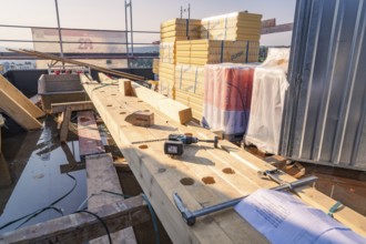 Construction site with wood and tools. Stack of building materials in bright sunlight, carpentry,