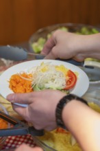 A plate of fresh salads and vegetables is served
