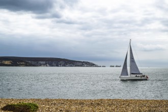 Yacht over Hurst Spit, Milford on Sea, Lymington, Hampshire, UK