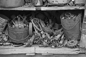 Collection of tools in an old cupboard in the courtyard, on a former Franconian farm, black and