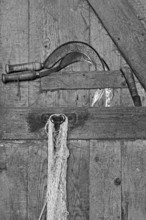 Sickles at the stable door, on a former Franconian farm, black and white, Franconian farm, Bavaria,