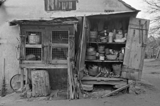 Collected utensils in a former rabbit stable, on a former Franconian farm, black and white,