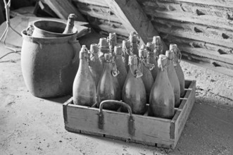 Old wooden beer crate with beer bottles from the 1940s in the attic, on a former Franconian farm,