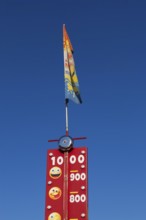 Close-up of High Striker game of strength with numbered score levels at Fun Show traveling