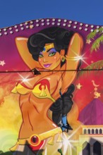 Colourful illustration of voluptuous green eyed Arabian belly dancer painted on amusement ride at