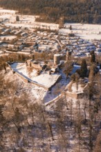 Medieval castle ruins on a wooded hill in a snowy village, Nagold, Calw district, Black Forest,