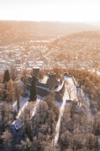 Castle on a wooded hill surrounded by a snowy urban landscape, Nagold, Calw district, Black Forest,