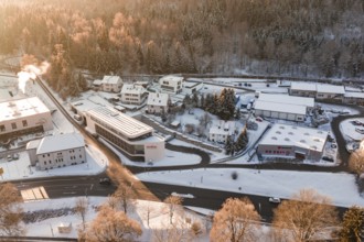 Snowy buildings and roads in an industrial and residential area during winter, Nagold, Calw