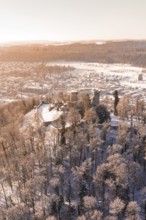 Snow-covered castle on a hill with forest and city in the background, Nagold, Calw district, Black